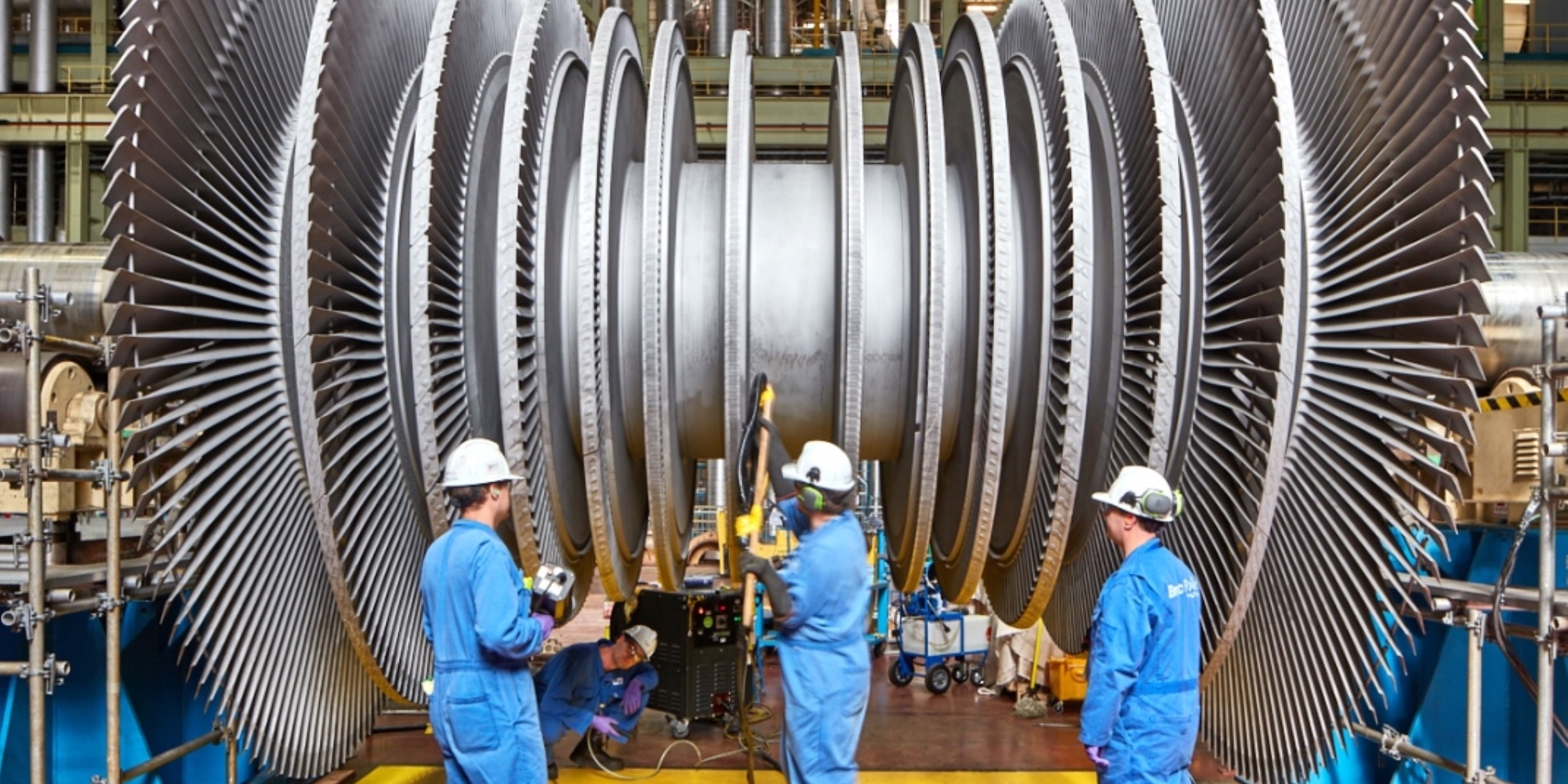 Employees in front of turbine rotor