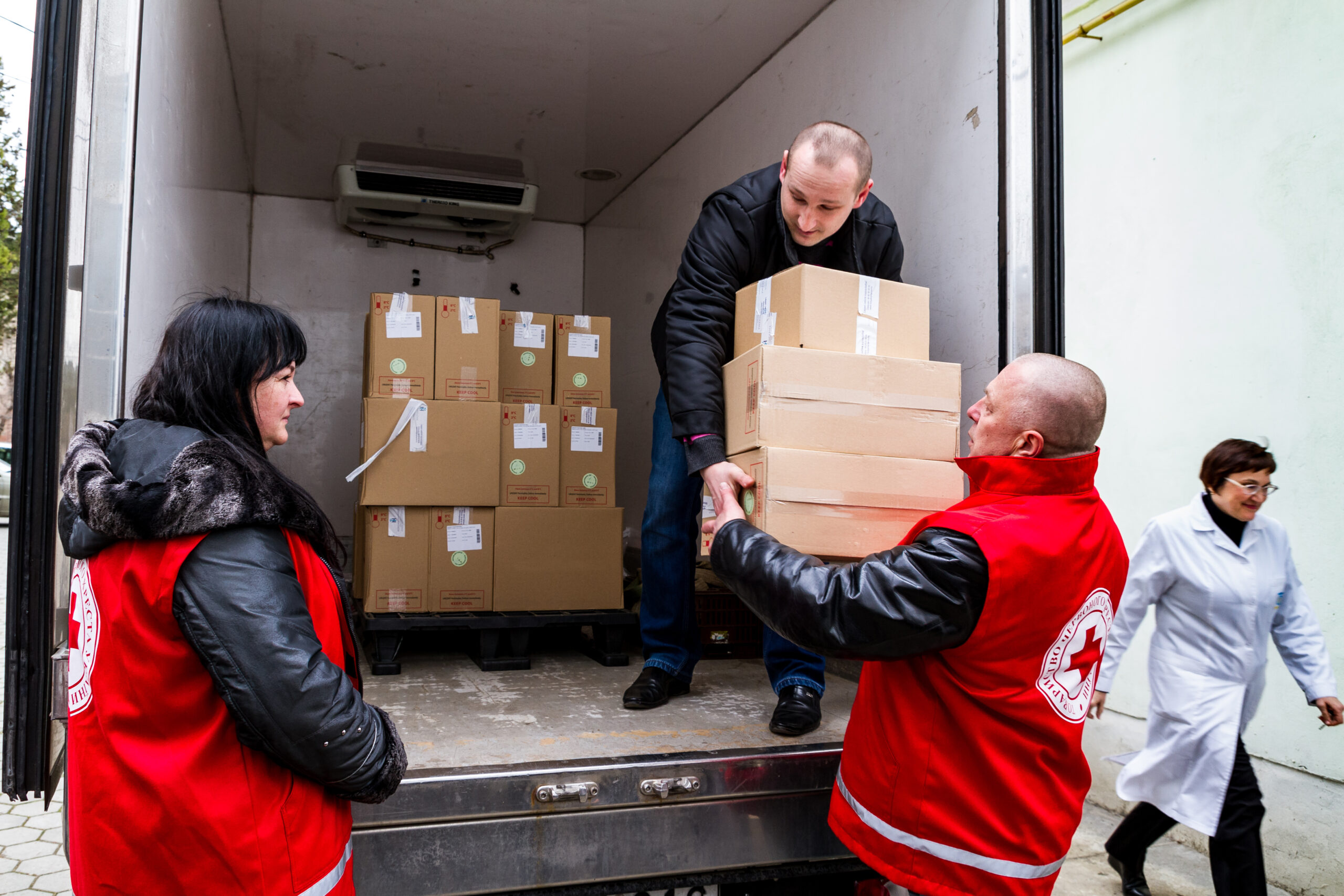 Red Cross workers unload humanitarian aid items for Ukraine.