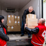 Red Cross workers unload humanitarian aid items for Ukraine.