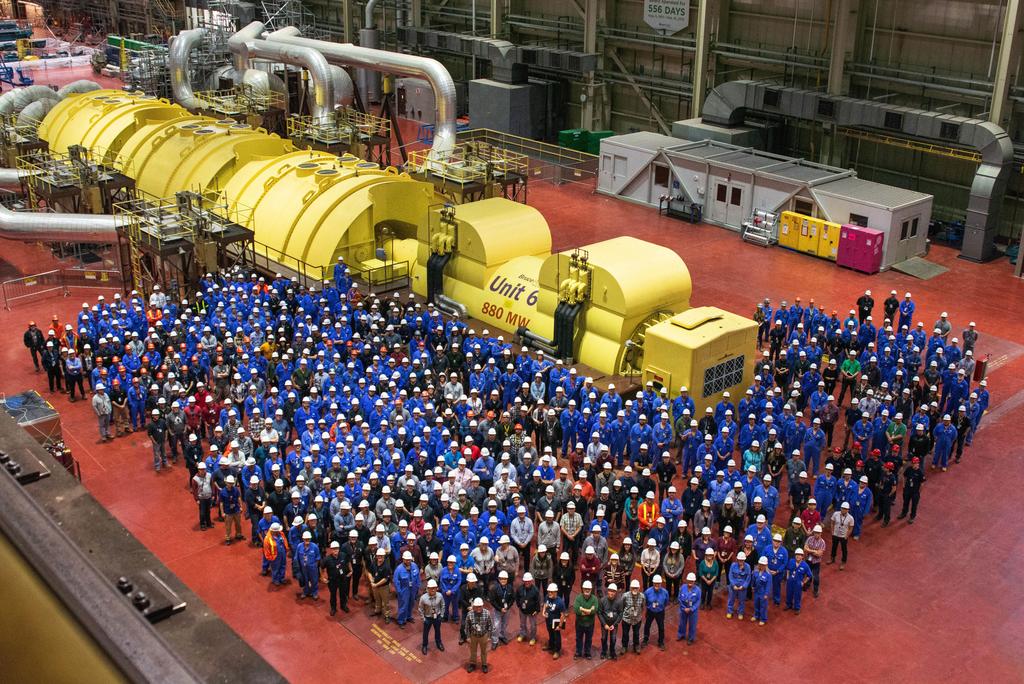 Group shot in front of Unit 6 turbine with workers gathered. Major Component Replacement.