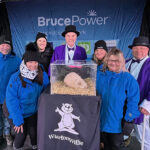 Bruce Power employees gather around Wiarton Willie as he makes his annual prediction.