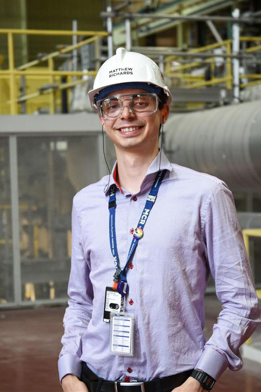 Photograph of Matthew Richards standing inside one of the Bruce Power stations.