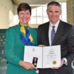 Pam Damoff, Member of Parliament for Oakville North-Burlington and Parliamentary Secretary to the Minister of Foreign Affairs, presents James Scongack with the King Charles III Coronation Medal on behalf of the Government of Canada.