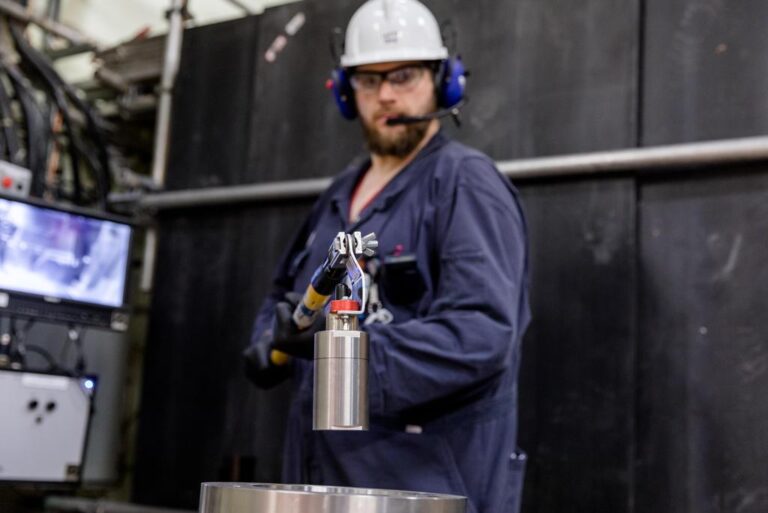 Bruce Power Isotope Production System worker loading a target into the system.