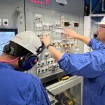 SNO Chris Hewitt and Ryan Whitehead perform the pre system checks on the Isotope Production System before loading the first targets to be irradiated in the second guide tube TFT2.