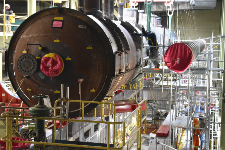 A massive steam drum is moved into place above a row of steam generators, marking a milestone in Bruce Power's Unit 3 Major Component Replacement project with all eight new steam generators now in place.