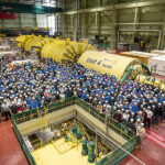 Workers gather on the Unit 4 Turbine Hall floor to commemorate the Unit 4 MCR outage.