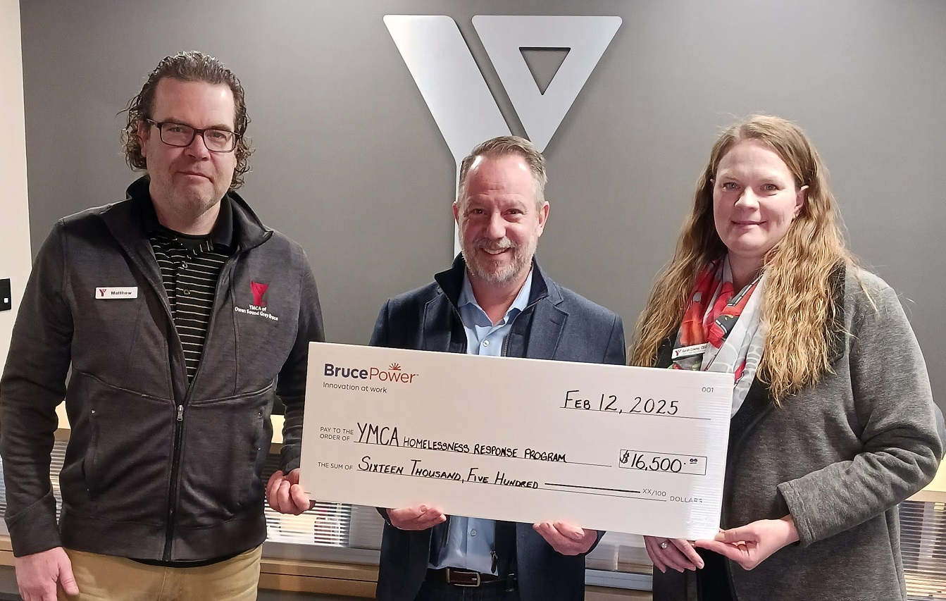 Bruce Power’s John Peevers, centre, presents a donation to Matthew Shute and Sarah Cowley of the YMCA of Owen Sound Grey Bruce in support of the Homelessness Response Program.