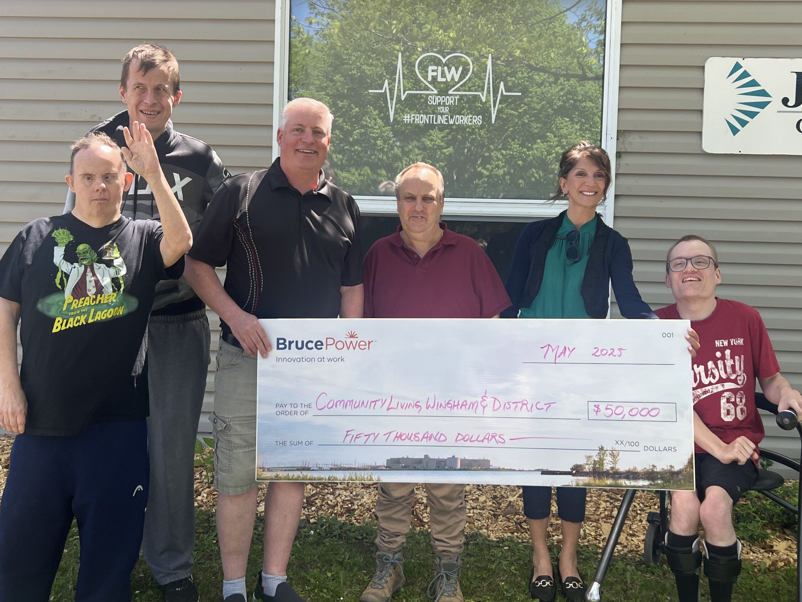 Group photo of some members of the Community Living Wingham and District holding a donation cheque.