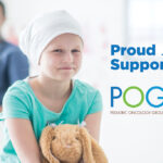 Young patient in hospital setting with teddy bear and words saying proud supporter of POGO