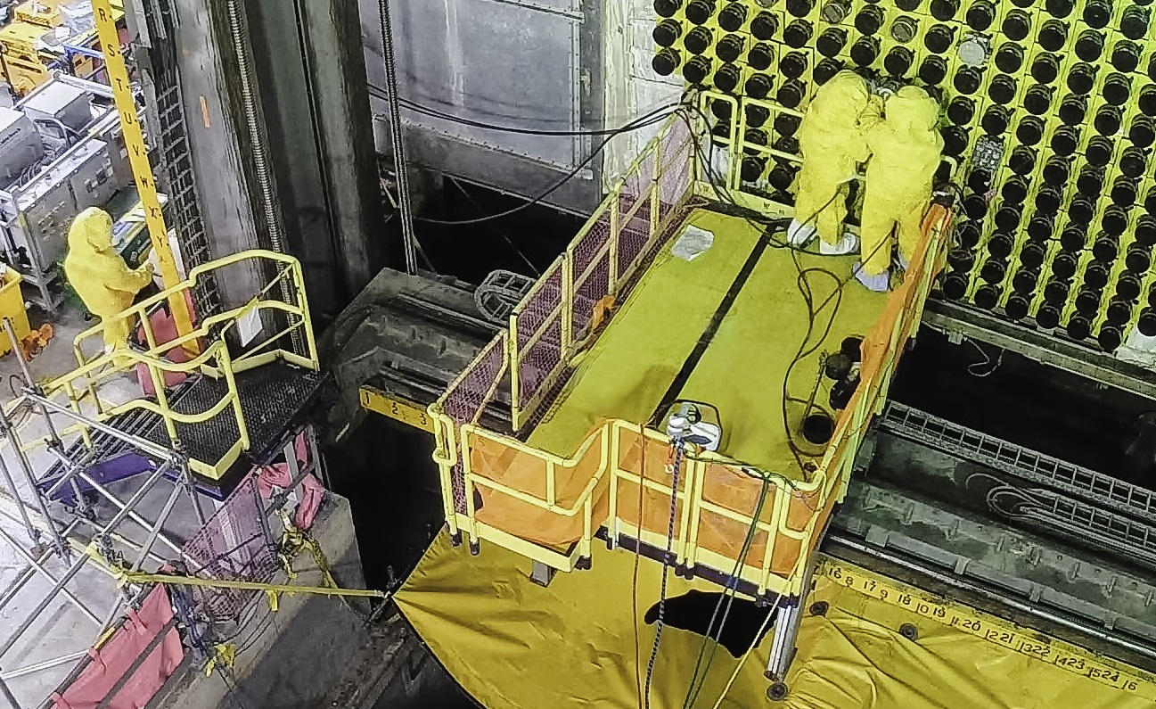 Unit 4 reactor face with two workers in yellow suits