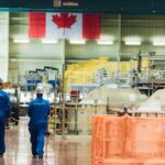 Bruce Power workers shown walking in the turbine hall.