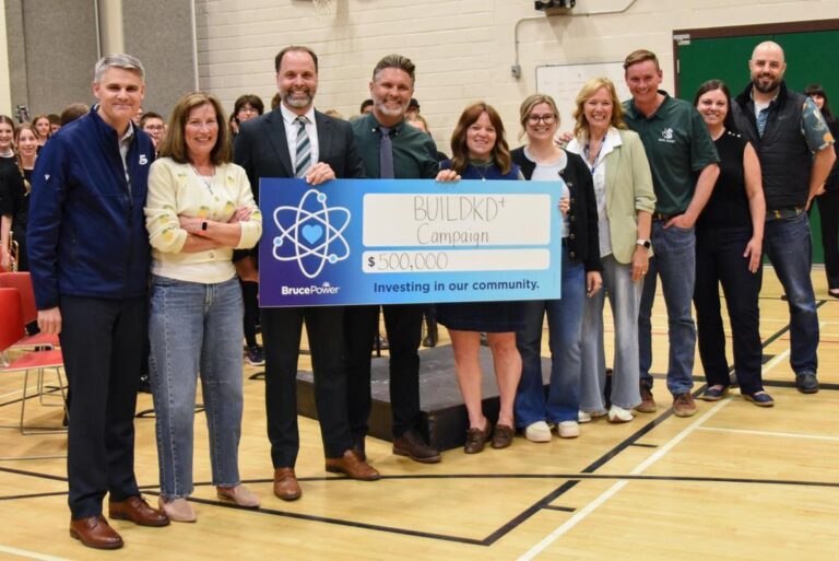 Bruce Power’s James Scongack, left, was on hand at the Kincardine District Senior School (KDSS) Banding Together concert May 14 to donate $500,000 to the BUILDKD+ campaign through the company’s Community Investment Fund.