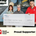 Bruce Power cheque presentation to Ronald McDonald House. Graphics of both organizations saying proud supporter.
